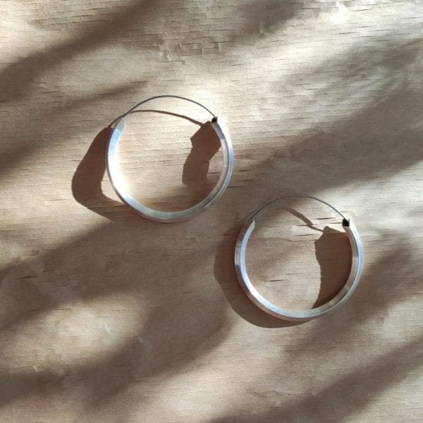 3/4 silver hoop with wire on dappled light brown background