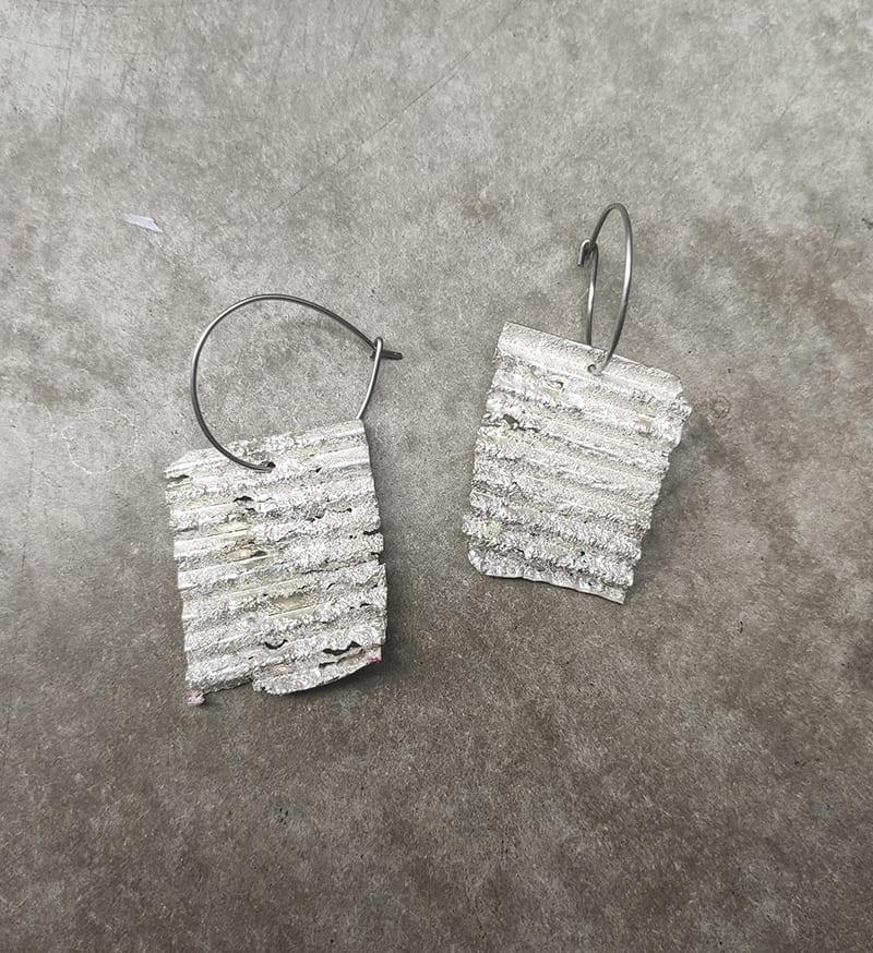 corrugated silver panels on loop, on smudge grey background