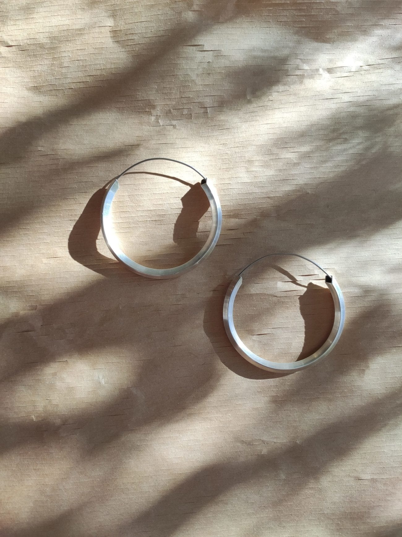 3/4 silver hoop with wire on dappled light brown background